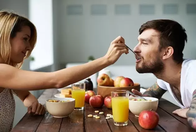 the woman feeds the man nuts to increase power